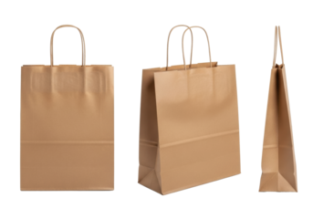 Three empty plain brown kraft paper shopping bags with twisted handles in various views against a pristine transparent background with copy space, sustainable packaging concept