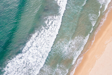 Turquoise ocean waves and beach aerial view, natural background.