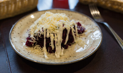 dish of beets, cheese, mayonnaise on a plate in restaurant