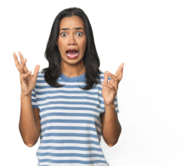 Young Latina posing in studio screaming to the sky, looking up, frustrated.