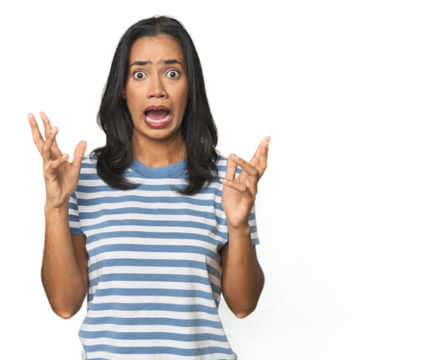 Young Latina posing in studio screaming to the sky, looking up, frustrated.