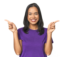 Young Latina posing in studio pointing to different copy spaces, choosing one of them, showing with finger.
