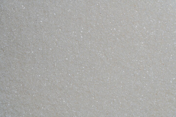 White granulated sugar on background, top view, closeup. The concept of unhealthy eating, obesity, heart disease, diabetes