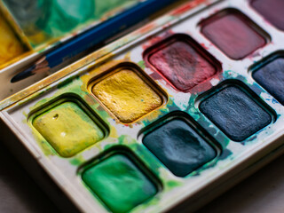 Colorful Watercolor Paint Palette Close-up - Artist Gouache Colors and Creative Art Supplies in Action.