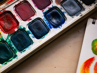Colorful Watercolor Paint Palette Close-up - Artist Gouache Colors and Creative Art Supplies in Action.