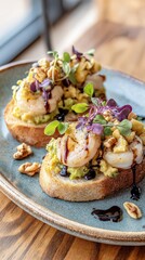 Avocado toast with shrimp, microgreens, chopped nuts and balsamic glaze on artisan bread