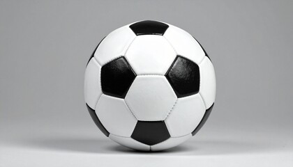 Classic black and white soccer ball centered on plain gray background