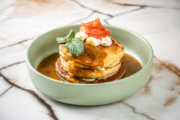 Savory pancakes with smoked salmon and creamy sauce.