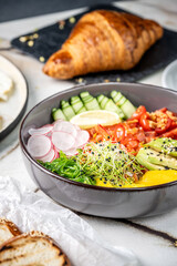 A vibrant healthy bowl with fresh vegetables and avocado.
