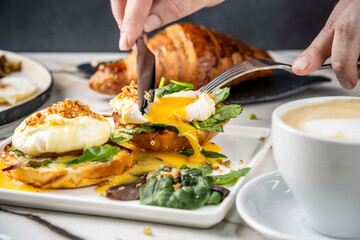 Poached eggs on toast with greens and coffee