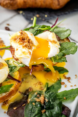 Close-up of poached egg with runny yolk on toast