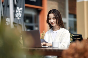 Women using tablets in outdoor cafes