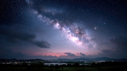 Fototapeta premium Night Sky Above Rural Landscape with Starry Milky Way Galaxy and Clouds in Blue Purple Hues Nighttime Scenery
