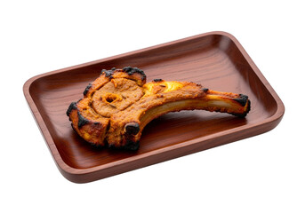 A single, flavorful, grilled lamb chop sits on a rich brown wooden platter, presented against a stark black background.