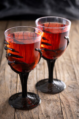 Halloween spooky red cocktail in skeleton hand glass