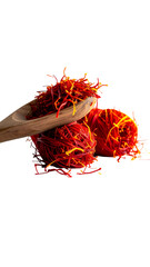 Crimson saffron threads nestled on a wooden spoon and small piles, dark background