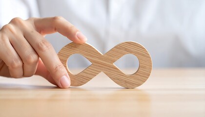 Businesswoman hand touching wooden infinity symbol of connection