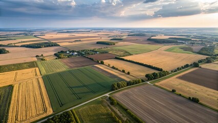 Aerial view of diverse farmland textures highlighting agricultural practices and crop patterns during golden hour