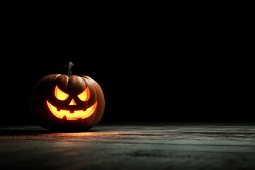 Spooky jack-o’-lantern glowing at corner, wide empty black space for copy