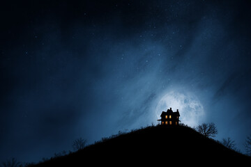 Haunted house on hill glowing, night sky background for copy