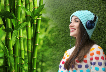 Happy woman listening to sounds of nature which making her feel calm. Double exposure with bamboo plants