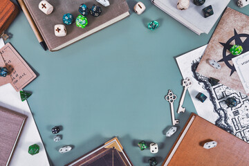 Tabletop role playing flat lay background with colorful RPG dices, rule books, dungeon map forming...