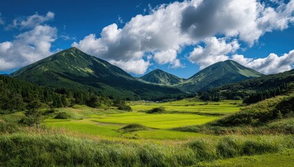 Lush green mountains, rice paddies, and a vibrant sky create a peaceful landscape.