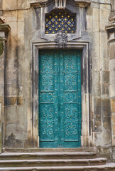 Ornate antique teal door of a historic chapel in Lviv, Ukraine.