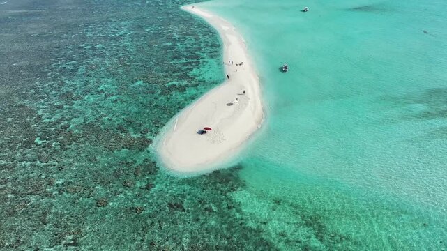 Aerial view of a pristine white sandbank meeting the turquoise sea, creating a stunning contrast of colors and textures, Thoddoo, Alif Alif Atoll, Maldives.