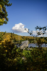 Autumn view of the bridge over the river 