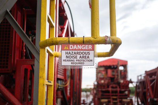 High noise working area warning, required to wear hearing protection. The safety sign at industrial refinery process plant. 