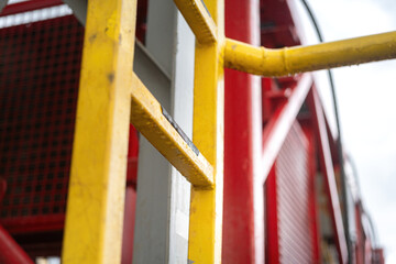 Close-up at ladder's step with anti-slip material of chemical mixing tank. Industrial 