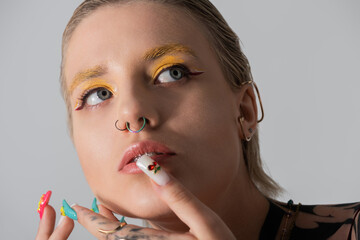 Elegant young woman showcases modern fashion and artistic flair in captivating close up portrait