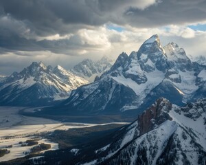 Majestic snow capped mountains under dramatic stormy skies