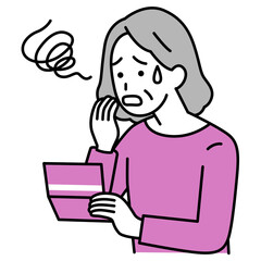 預金通帳を見て困惑する年配の女性