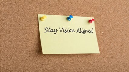 Motivational Note on Cork Board with Message to Stay Vision Aligned