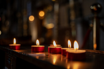 Flickering votive candles glowing warmly inside a Venetian church, symbolizing prayer, faith, and quiet devotion while filling the sacred space with peaceful light