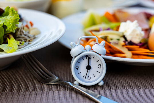 Alarm clock with IF (Intermittent Fasting) 16 and 8 diet rule and weight loss concept.-Diet plan concept