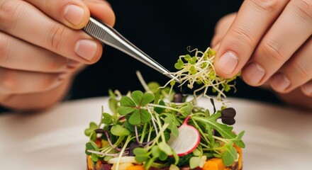 Man chef uses tweezers to place microgreens on a gourmet dish. Healthy eating and fine dining concept. Culinary art.