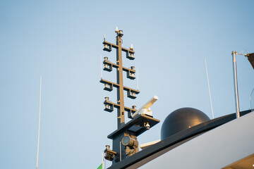 Detailed yacht radar mast with satellite dome, antennas and navigation lights, illustrating...