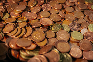 Pile of euro cent coins in various denominations, showing copper and brass tones, symbolizing small...