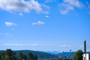 Scenic landscape with Swiss Alps in the background seen form rooftop of car park at Swiss Airport Zürich Kloten on a sunny late summer day. Photo taken September 15th, 2025, Zurich, Switzerland.