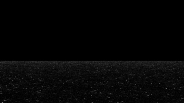 Rain falls on dark ground at night, creating ripples on wet surface. Moody, atmospheric, and dramatic shot for weather or cinematic scenes. Seamless loop with copy space above