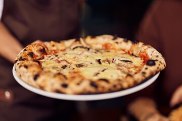 Freshly Baked Crispy Crust Pizza with Cheese and Mushrooms on a White Plate