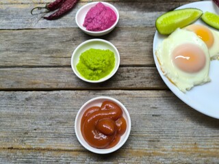 delicious mouth-watering breakfast of fried eggs and sausages on a plate