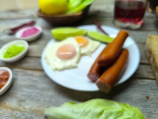 delicious mouth-watering breakfast of fried eggs and sausages on a plate
