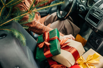 Wrapped Christmas gifts on car seat during holiday homecoming