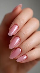 Close-up of elegant pink manicure on female hand with gradient nail polish