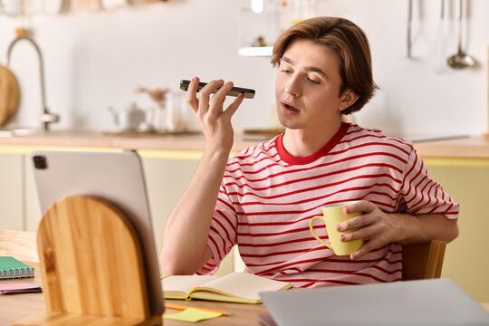 Young man engages in online learning from his stylish apartment - Powered by Adobe