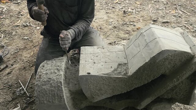 Stone Carving - Stone Art in India. Indian stone mason Creating abstract sculpture Of granite Stone. Cutting rock with grinder, chisel and hammer with traditional technique. Slow Motion 4k Footage